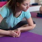 Yoga class with women in pose.
